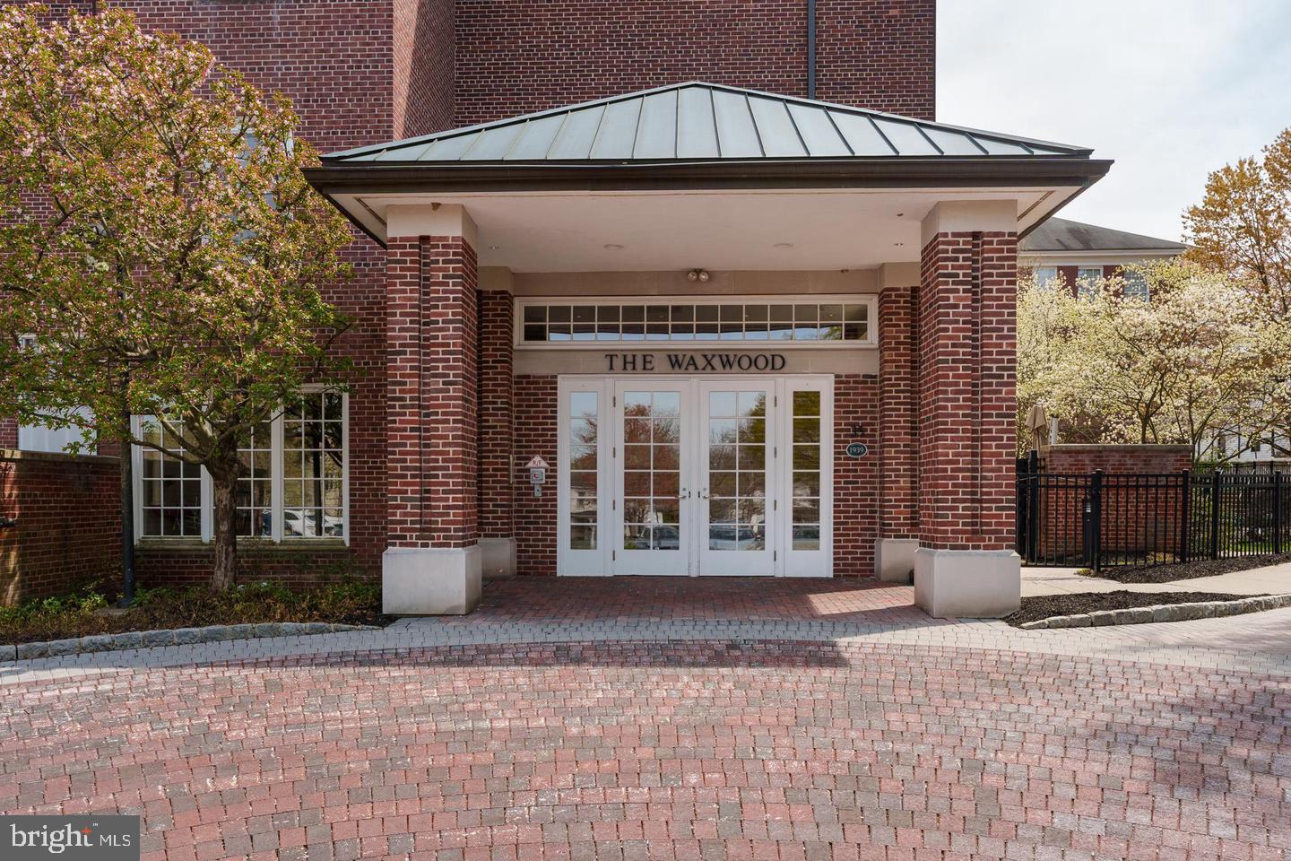 35 Quarry Street, Unit 104 Princeton, NJ 08542 - Photo 2 of 12 a front view of a house with a garden
