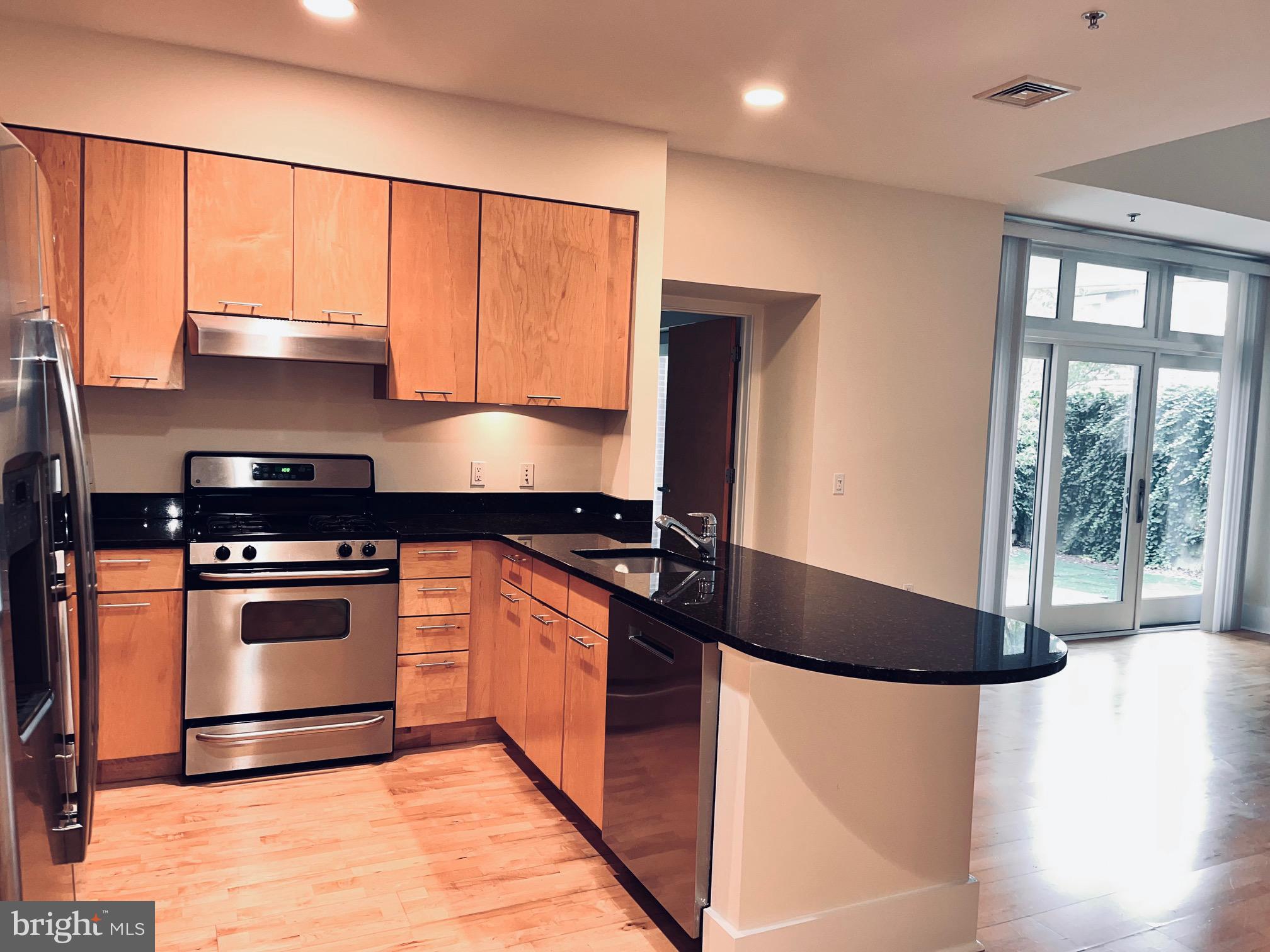 35 Quarry Street, Unit 104 Princeton, NJ 08542 - Photo 5 of 12 a kitchen with stainless steel appliances granite countertop a stove a sink and a microwave