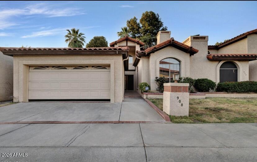 908 West Flynn Lane Phoenix, AZ 85013 - Photo 1 of 23 a front view of a house with a garden