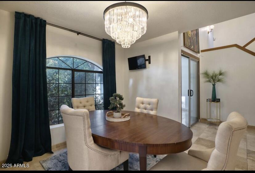 908 West Flynn Lane Phoenix, AZ 85013 - Photo 7 of 23 a view of a dining room with furniture wooden floor and a chandelier