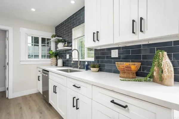 a kitchen with stainless steel appliances a refrigerator stove and sink