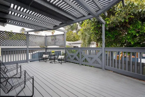 a kitchen with stainless steel appliances a stove a sink a refrigerator white cabinets and wooden floor