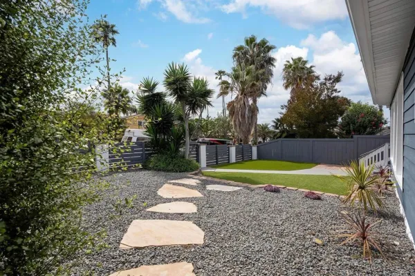 a view of a backyard with large trees