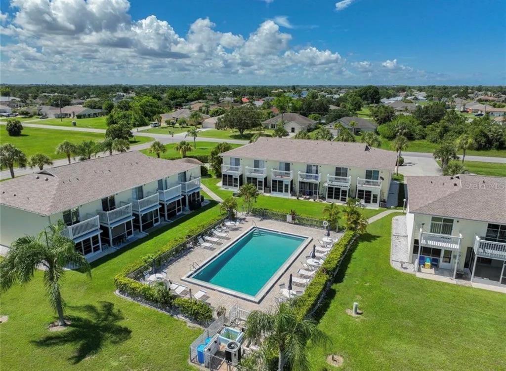 26272 Rampart Boulevard, Unit 107 Punta Gorda, FL 33983 - Photo 17 of 18 an aerial view of a house with a big yard