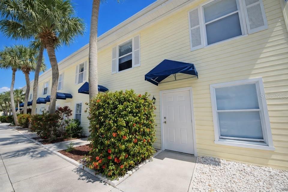 26272 Rampart Boulevard, Unit G107 Punta Gorda, FL 33983 - Photo 2 of 11 a front view of a house with garden