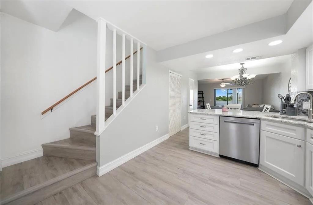 26272 Rampart Boulevard, Unit 107 Punta Gorda, FL 33983 - Photo 4 of 18 a view of kitchen with cabinets and wooden floor