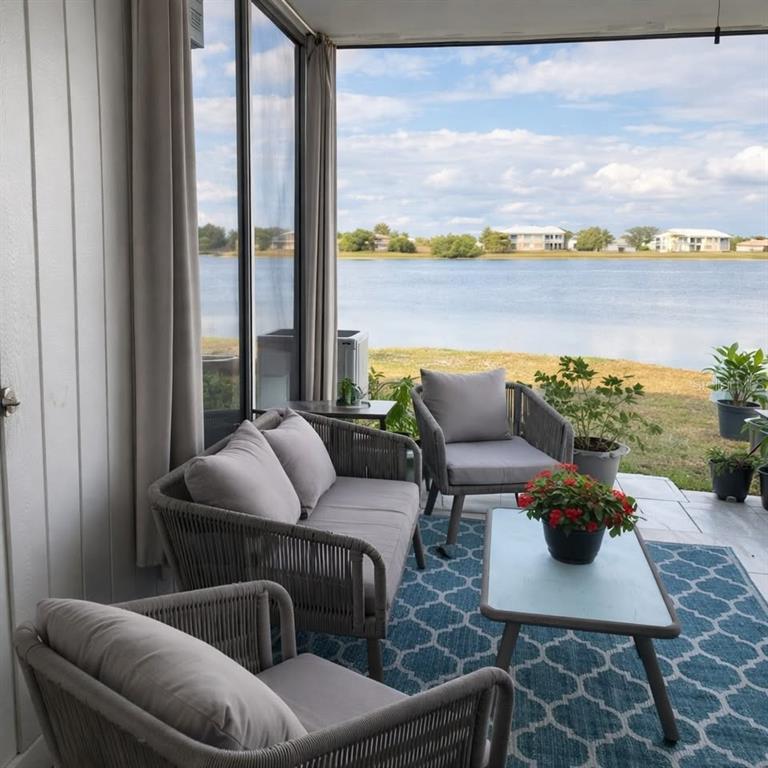 26272 Rampart Boulevard, Unit G107 Punta Gorda, FL 33983 - Photo 5 of 11 a living room with furniture and a floor to ceiling window