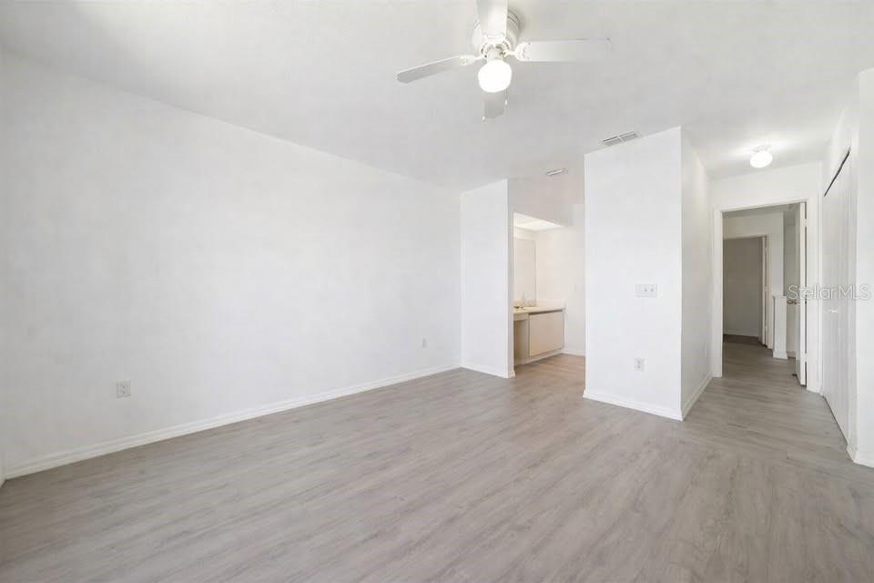 26272 Rampart Boulevard, Unit G107 Punta Gorda, FL 33983 - Photo 9 of 11 a view of an empty room with a ceiling fan