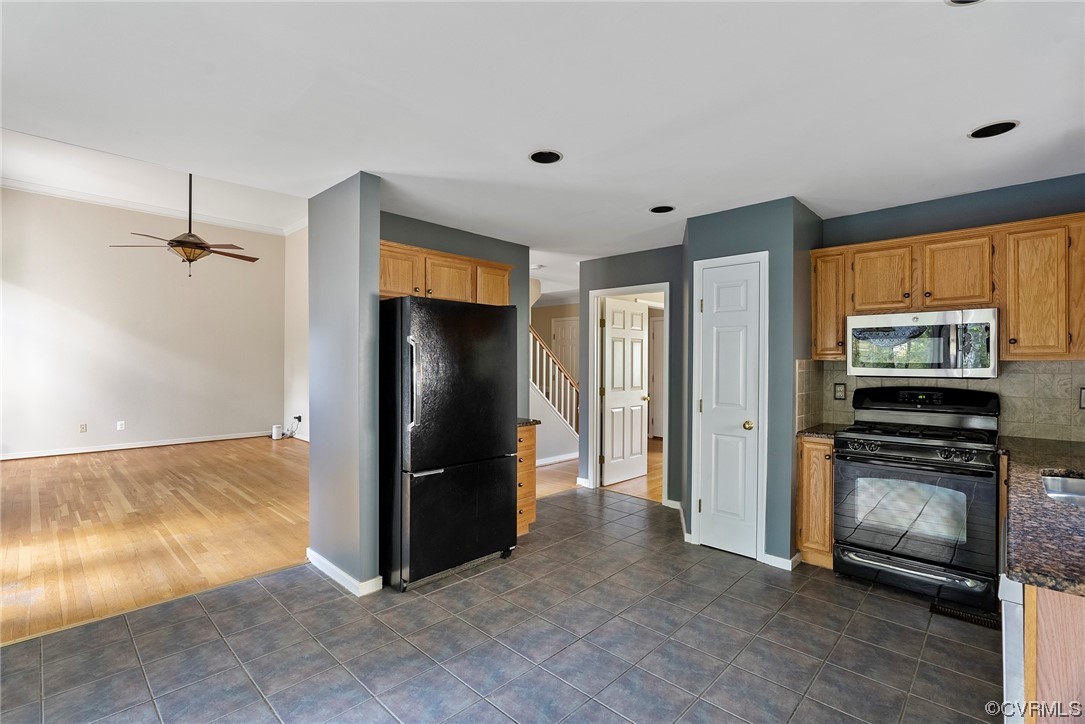 5407 Chestnut Bluff Road Midlothian, VA 23112 - Photo 13 of 35 a view of a kitchen with refrigerator and wooden floor