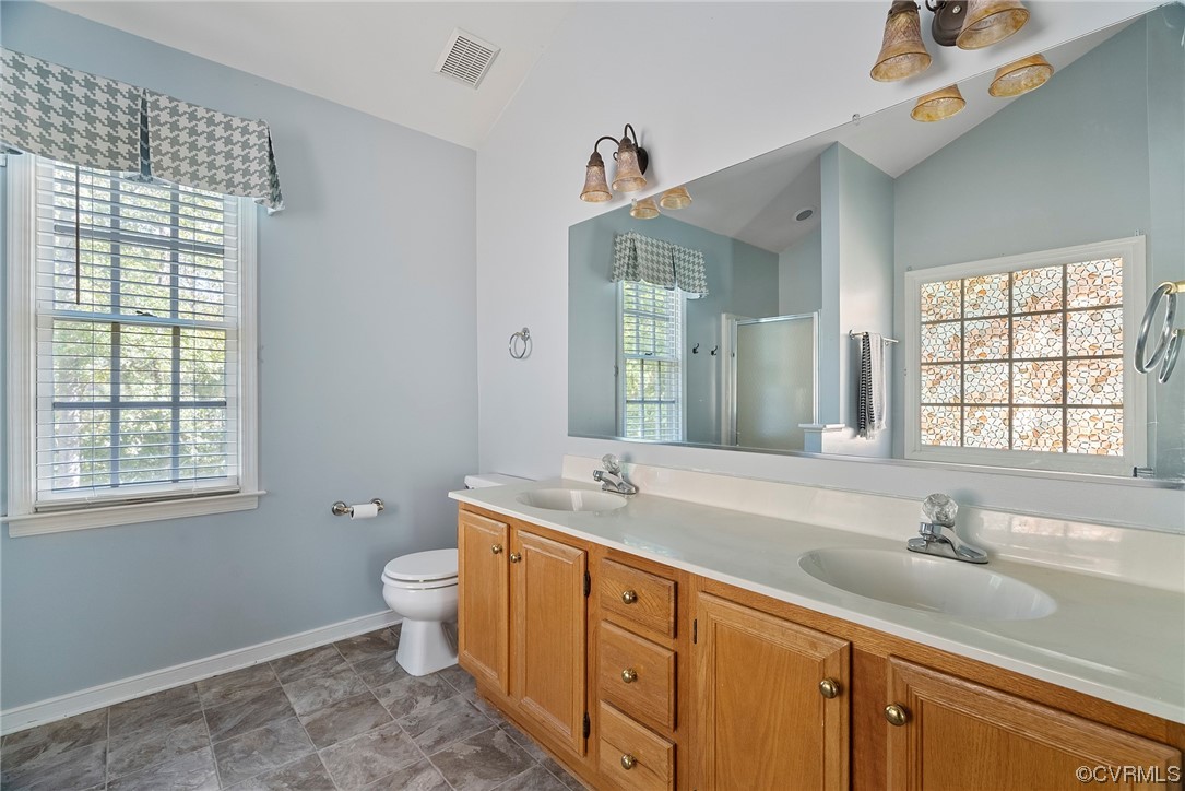 5407 Chestnut Bluff Road Midlothian, VA 23112 - Photo 24 of 35 a bathroom with a double vanity sink toilet and a mirror