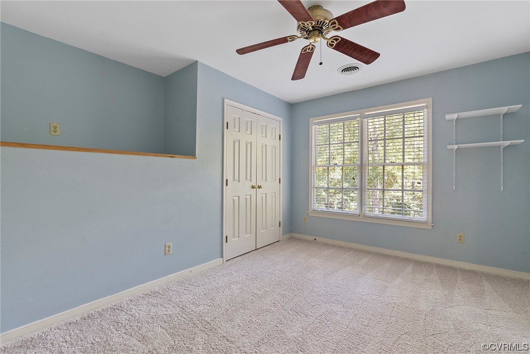 5407 Chestnut Bluff Road Midlothian, VA 23112 - Photo 26 of 35 a view of an empty room with window and a chandelier fan