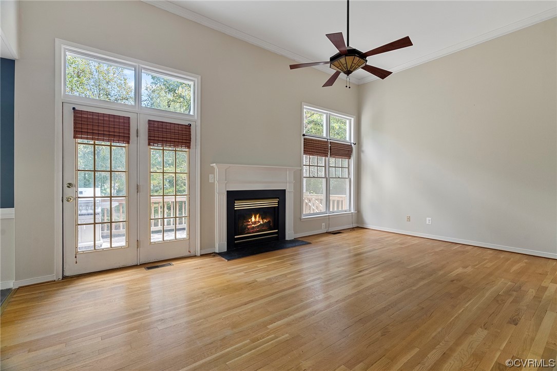 5407 Chestnut Bluff Road Midlothian, VA 23112 - Photo 7 of 35 an empty room with wooden floor fan and windows