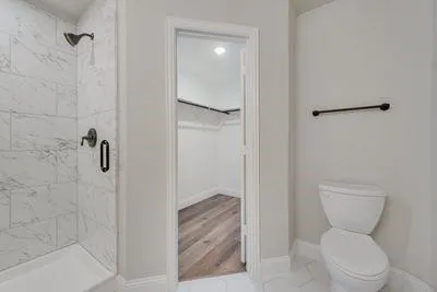 a bathroom with a toilet and a shower