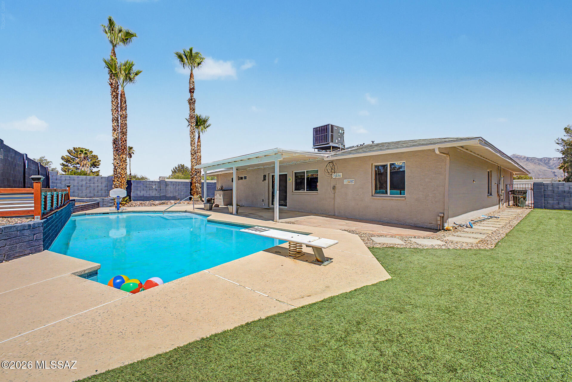 7550 East Rio Verde Drive Tucson, AZ 85715 - Photo 24 of 25 Palm trees, turf, and a refreshing pool come together to create your own private oasis.