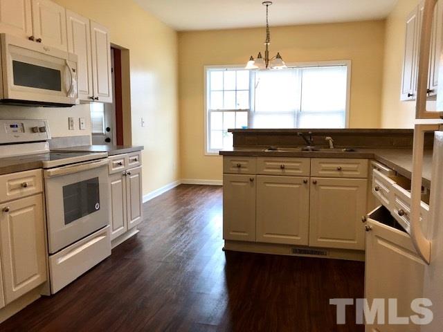 3832 Pin Oak Road Raleigh, NC 27604 - Photo 4 of 14 a kitchen with a stove window and cabinets