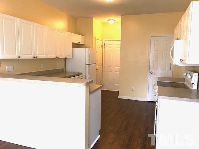 3832 Pin Oak Road Raleigh, NC 27604 - Photo 5 of 14 a kitchen with a refrigerator sink and cabinets