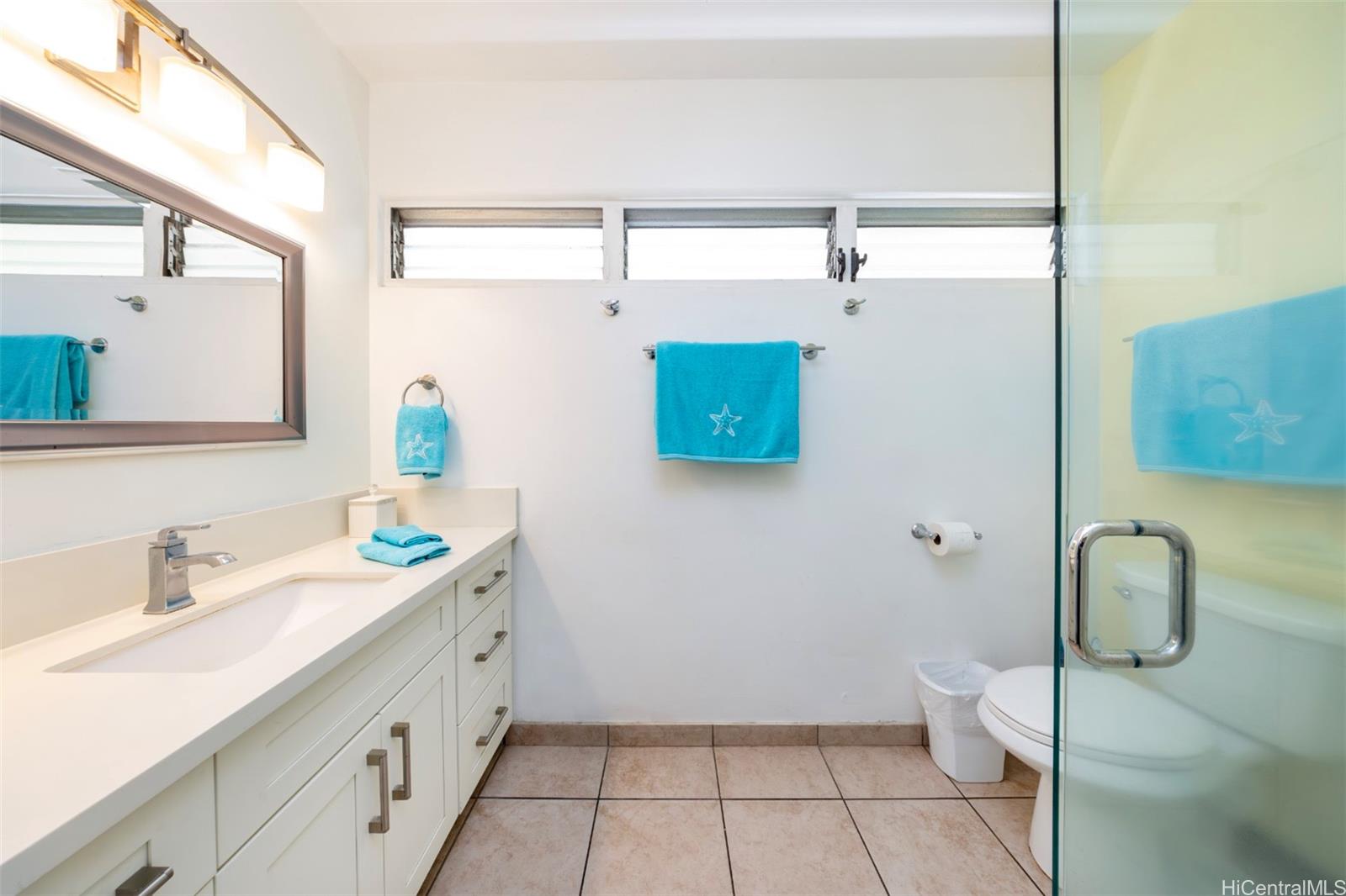 2161 Kalia Road, Unit 218 Honolulu, HI 96815 - Photo 18 of 25 a bathroom with a sink a toilet and mirror