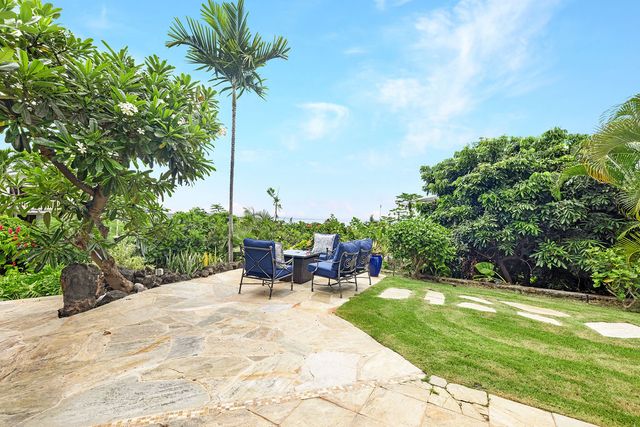 a view of a chairs and table in the patio with a fire pit