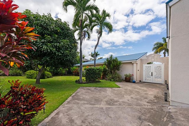 a kitchen with granite countertop a sink a stove and cabinets