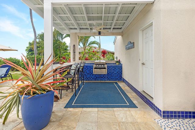 a view of a patio with table and chairs and potted plants