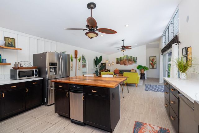 a dining room with a table chairs and a kitchen view