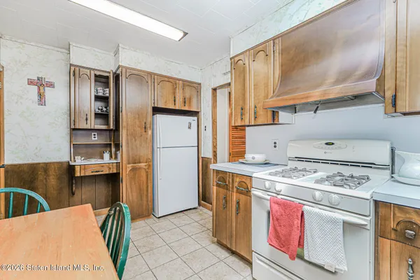 a kitchen with a stove and a refrigerator