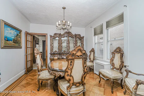 a view of a dining room with furniture and chandelier