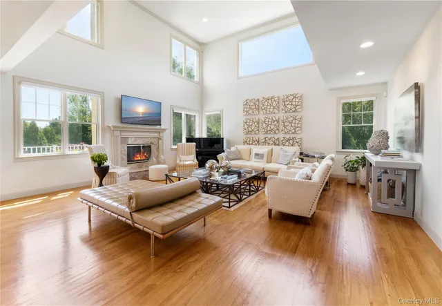 a living room with fireplace furniture and a wooden floor