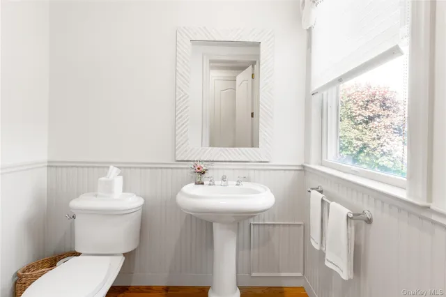 a bathroom with a sink toilet and a mirror