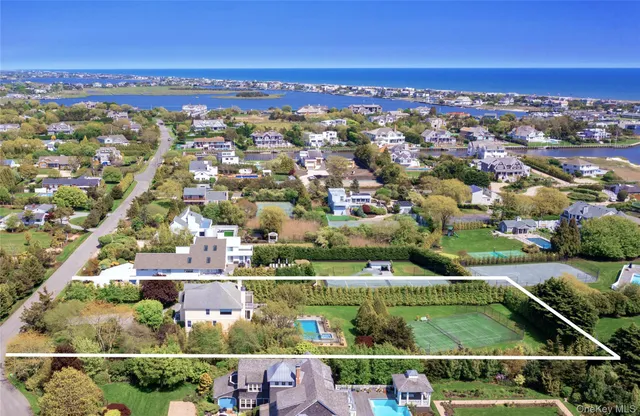 an aerial view of residential houses with outdoor space and swimming pool