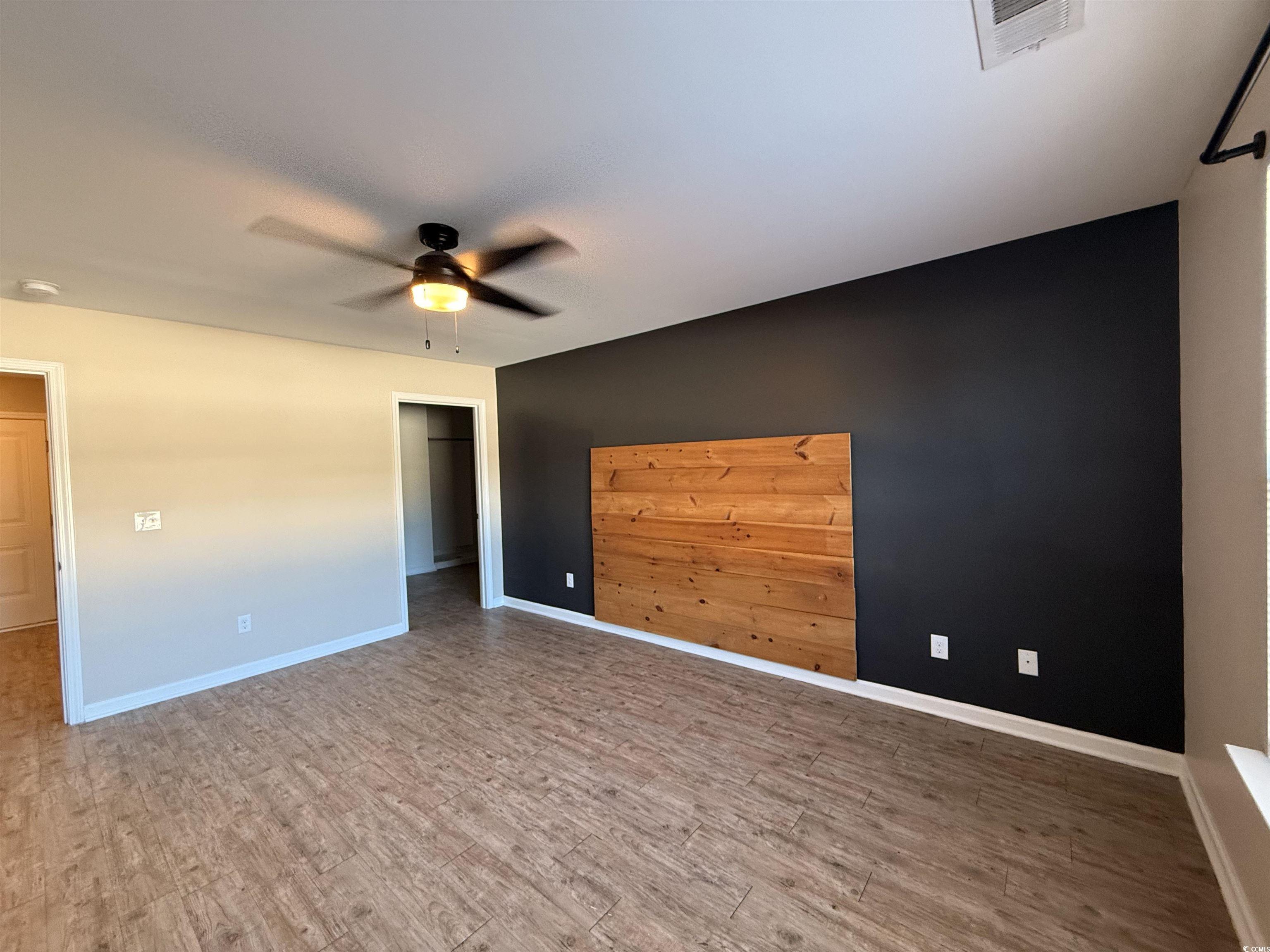 462 Quinta Street Longs, SC 29568 - Photo 12 of 39 Empty room with light wood finished floors and a ceiling fan