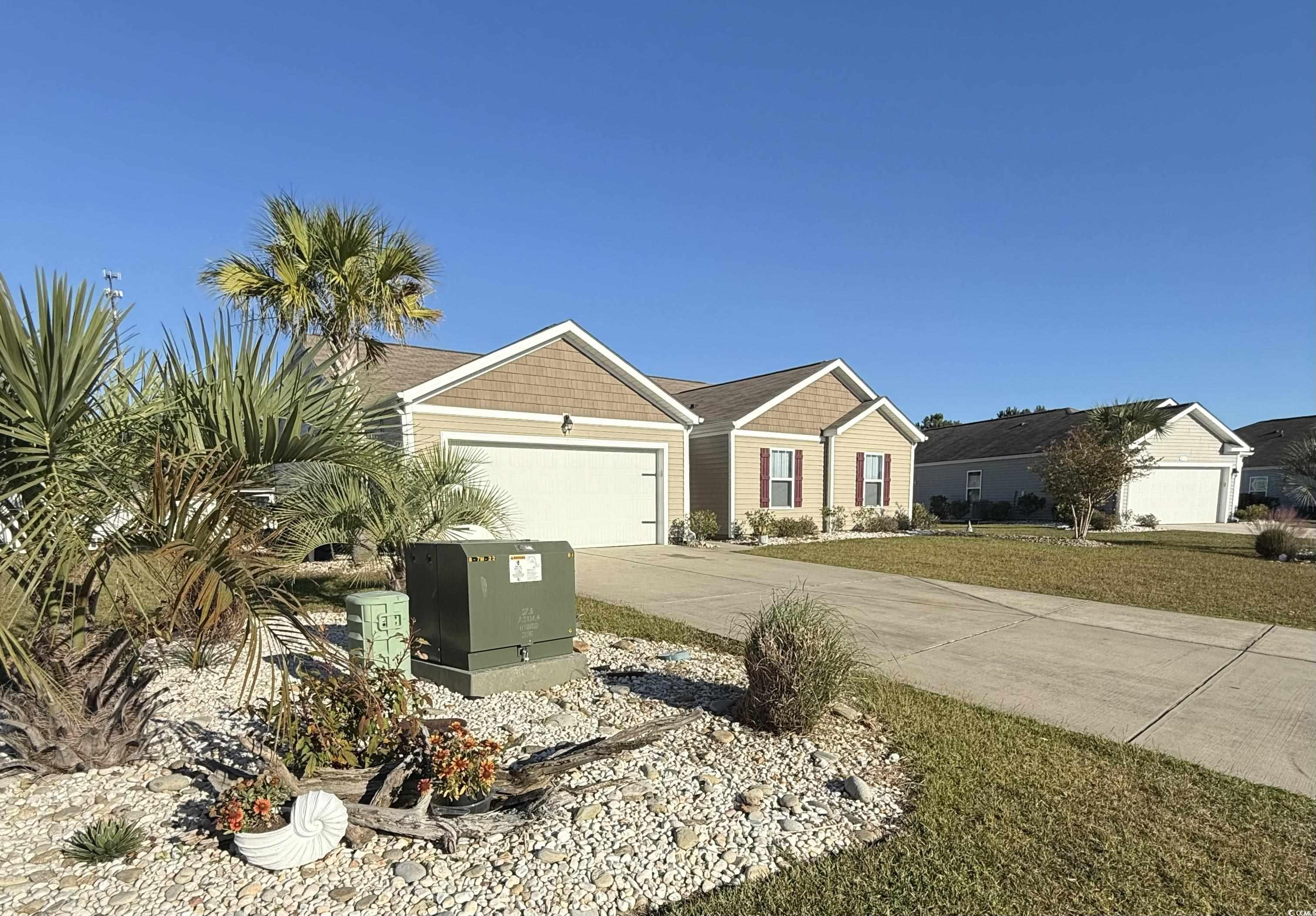 462 Quinta Street Longs, SC 29568 - Photo 3 of 39 View of front of property featuring concrete driveway, a garage, and a front lawn