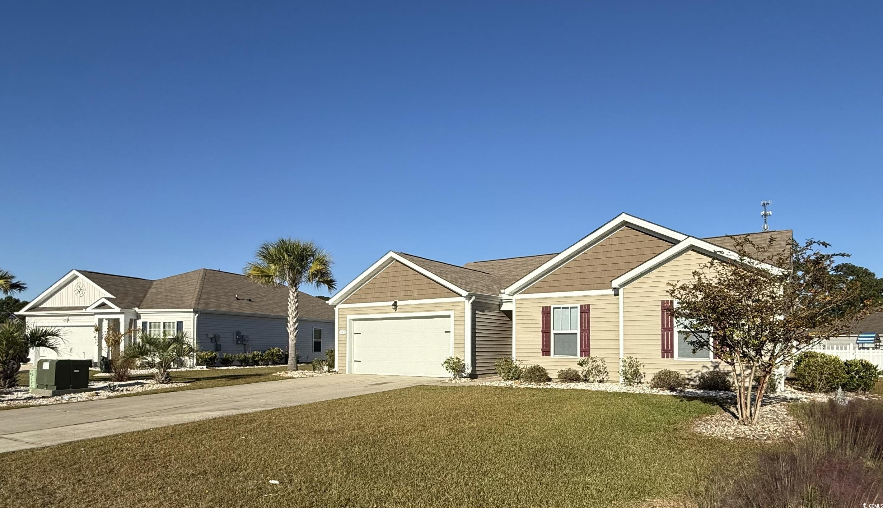 462 Quinta Street Longs, SC 29568 - Photo 4 of 39 Ranch-style home with concrete driveway, a front lawn, and a garage