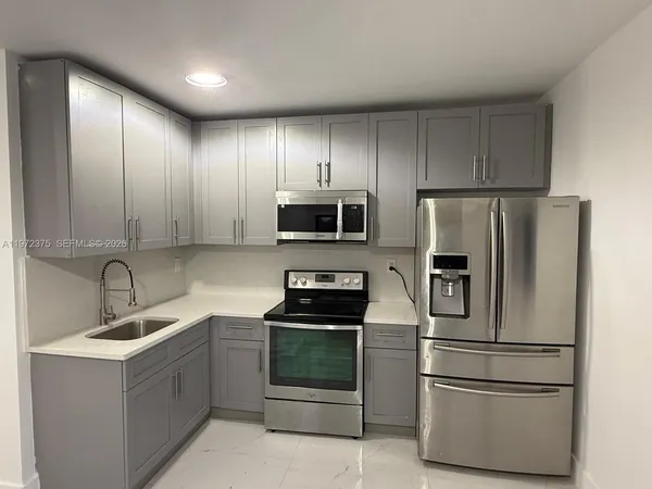 a kitchen with a refrigerator sink and microwave