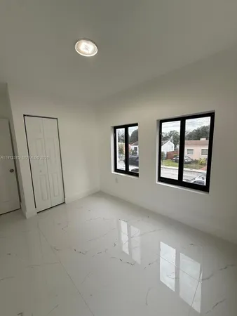 a view of an empty room with windows