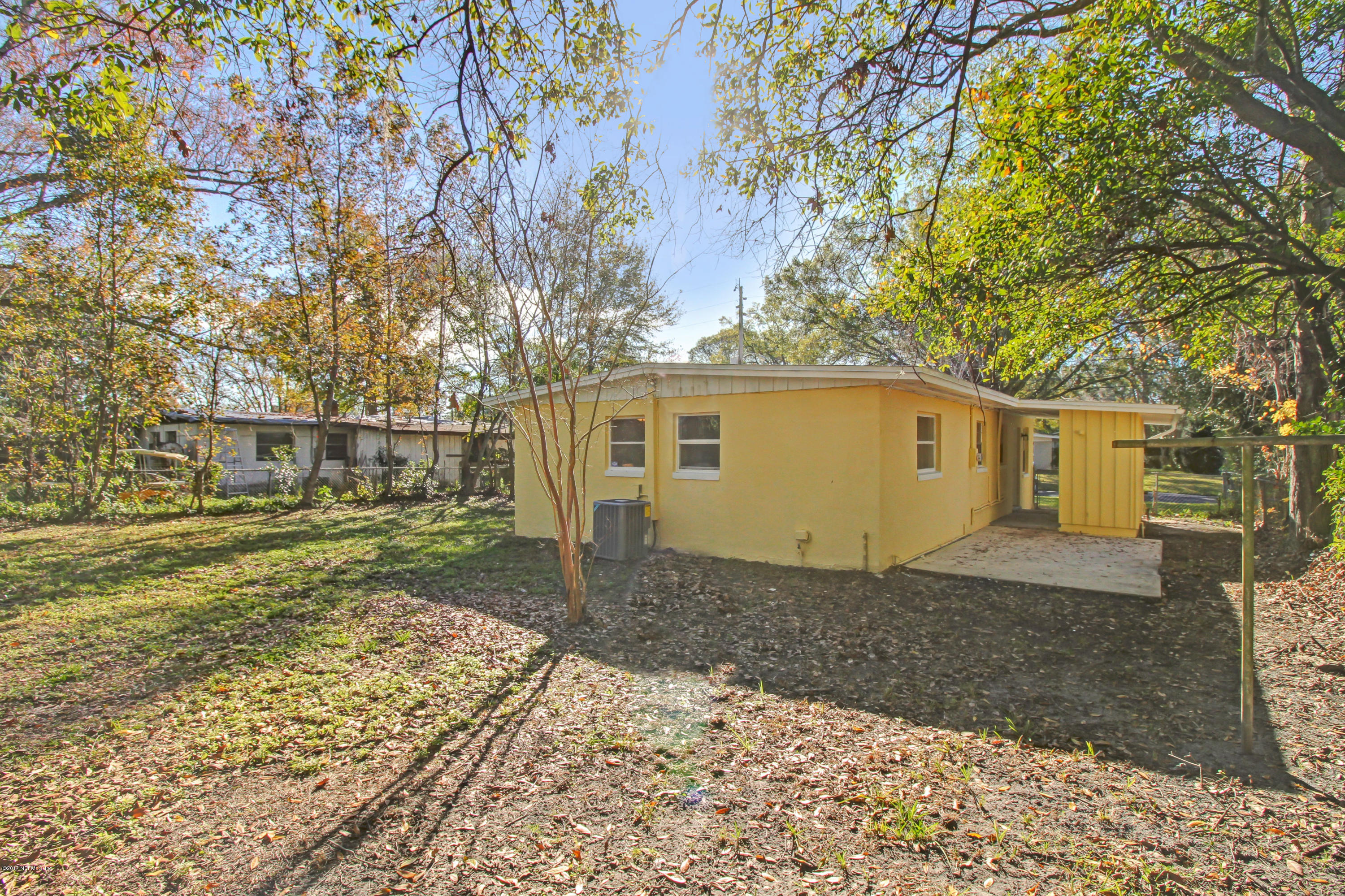 7003 Arques Road Jacksonville, FL 32205 - Photo 5 of 24 a front view of a house with a yard