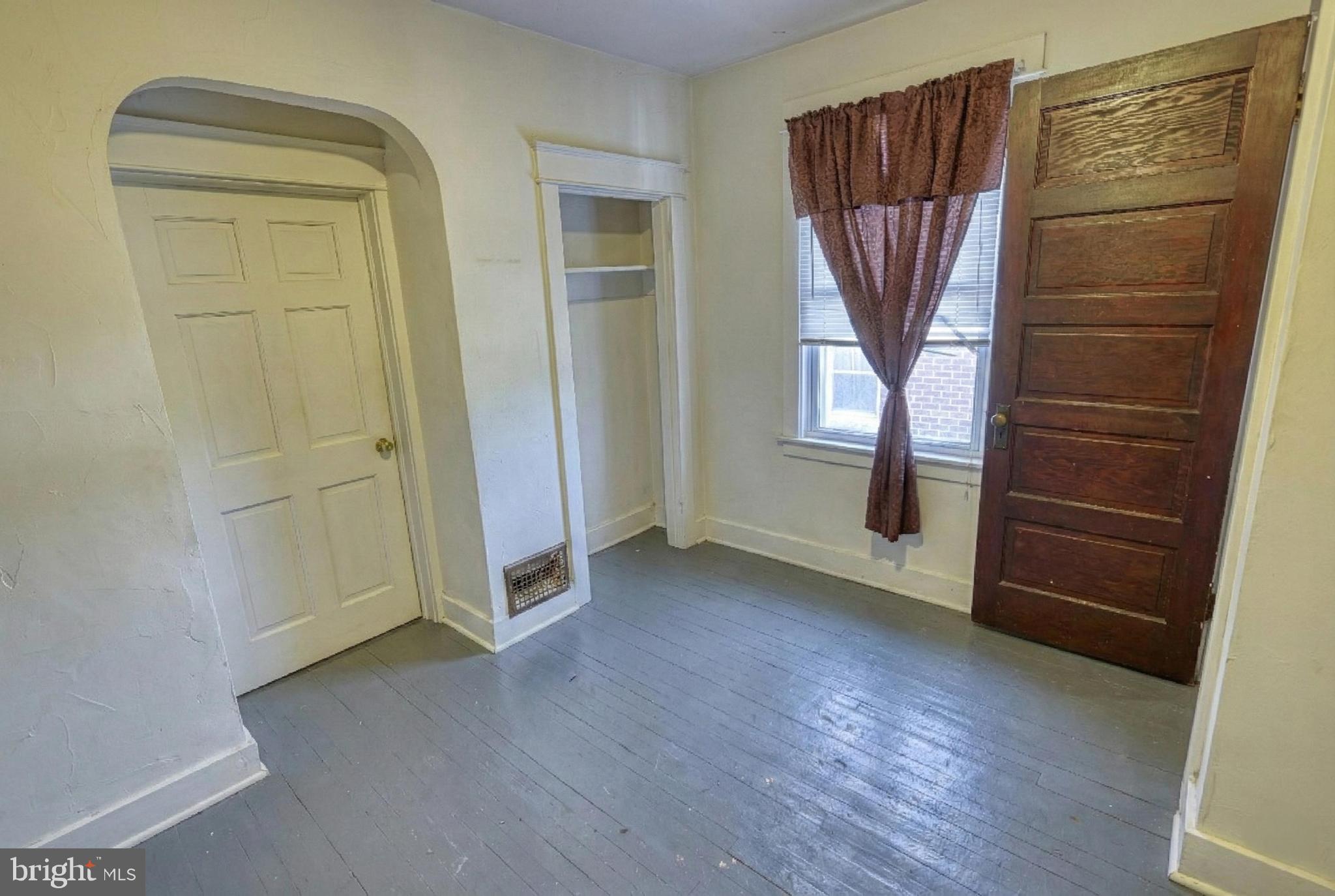 619 Dallas Street York, PA 17403 - Photo 18 of 23 an empty room with wooden floor cabinet and windows