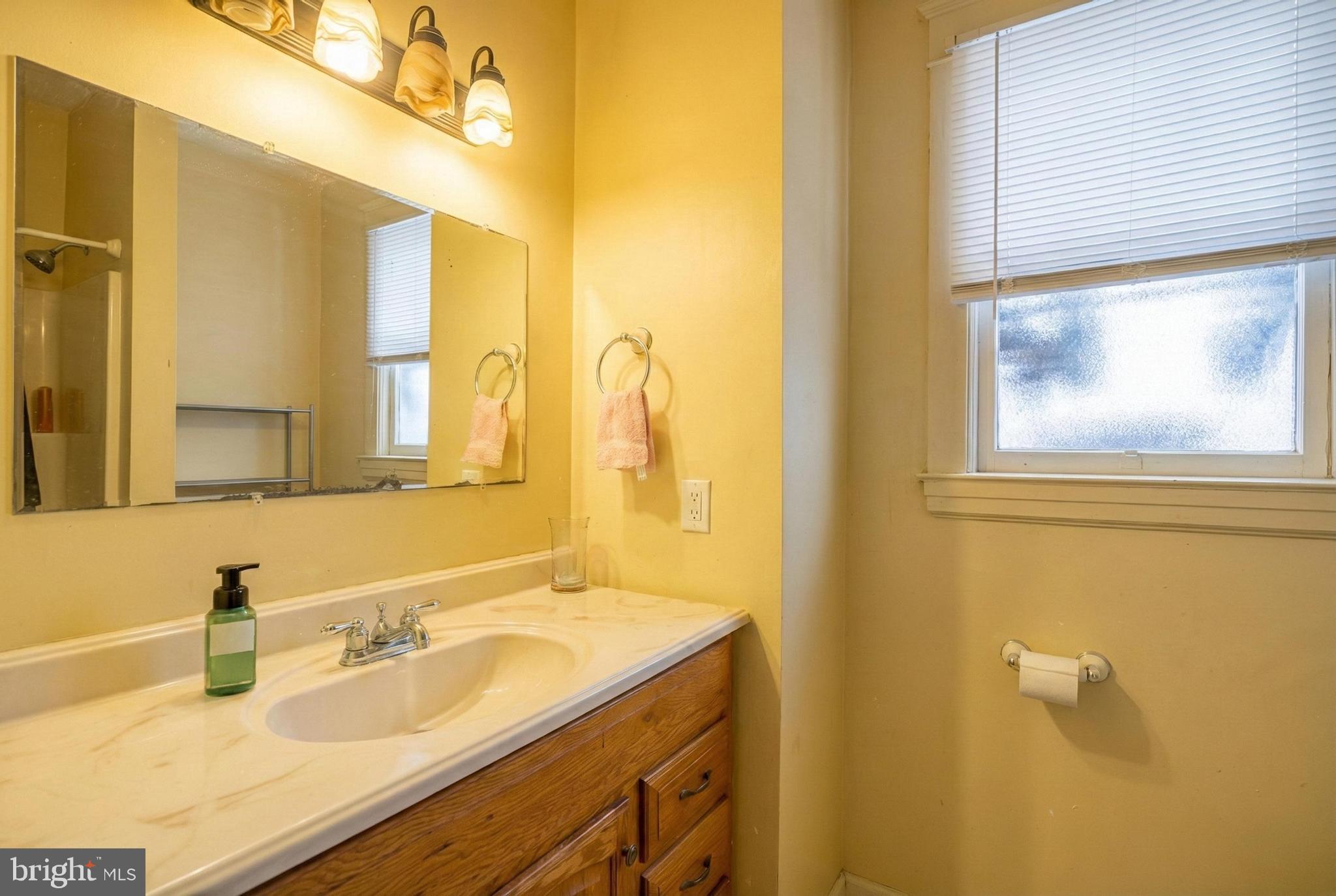 619 Dallas Street York, PA 17403 - Photo 19 of 23 a bathroom with a granite countertop sink and a mirror