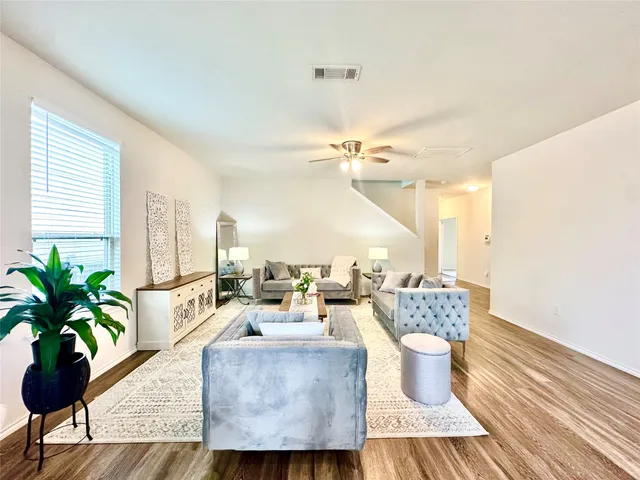 a living room with furniture and a potted plant