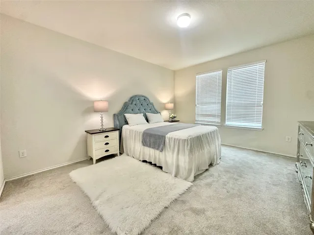 a bedroom with a bed and a night stand