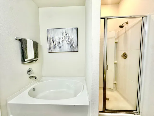 a bathroom with a tub and shower
