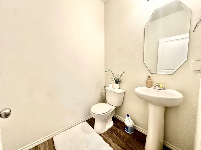 a bathroom with a sink toilet and a mirror