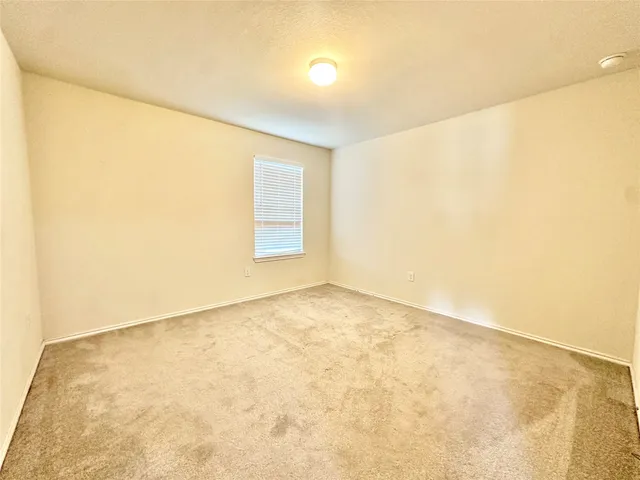 an empty room with a empty space and a window