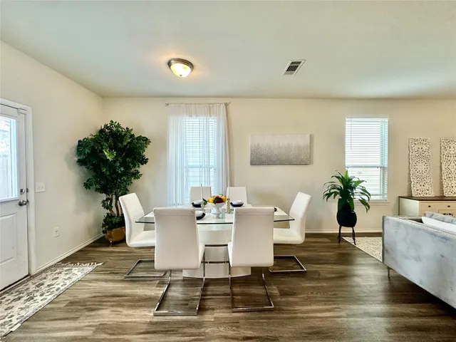 a view of a dining room with furniture window and wooden floor