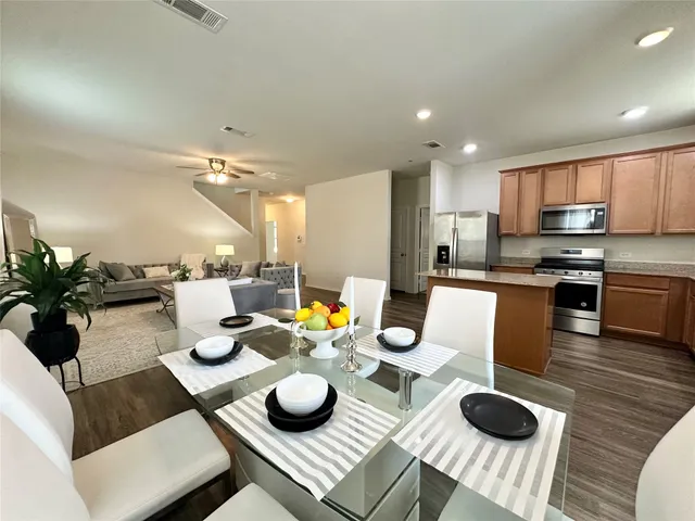 a kitchen with a table chairs and kitchen view