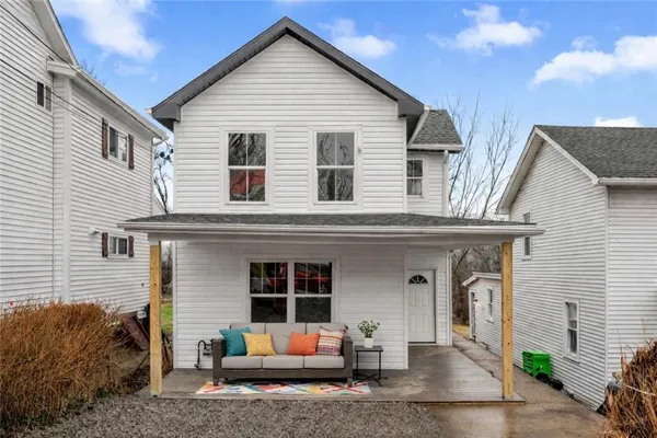 a view of a house with a yard and seating space