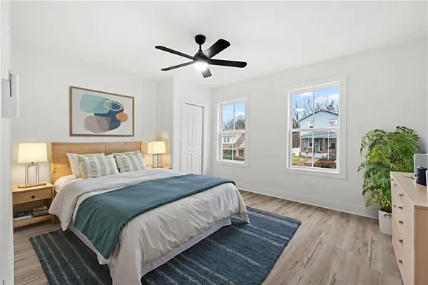 a bedroom with a bed and a window