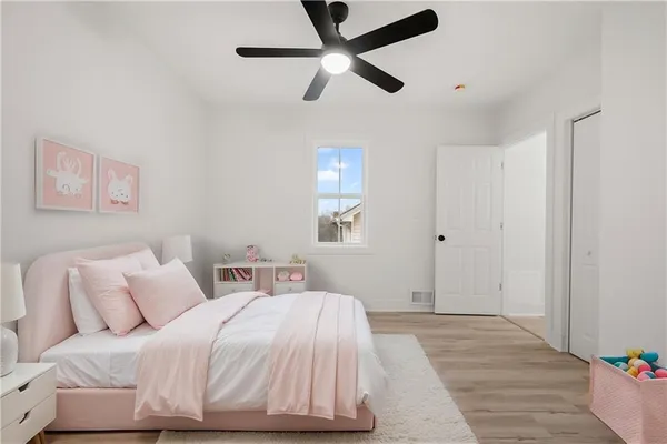 a bedroom with a bed and a ceiling fan