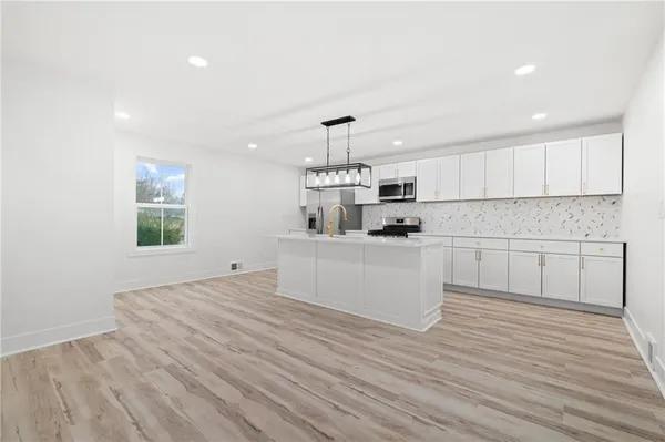 a kitchen with a wooden floor and window