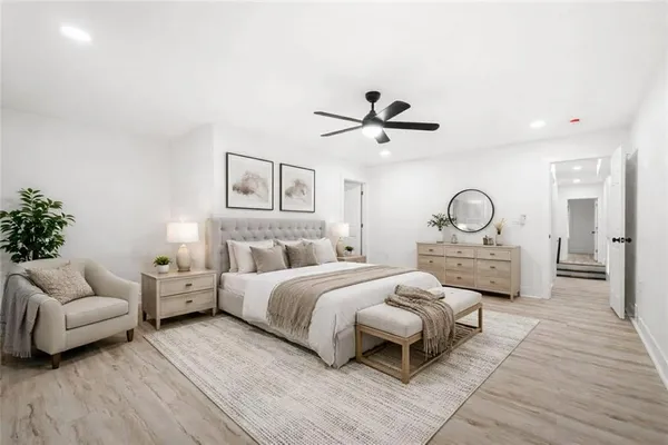 a bedroom with a large bed and a chandelier